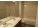 Bathroom featuring dual vanity sinks, a large mirror, and a tub-shower combination at 18784 E Linvale Pl, Aurora, CO 80013