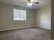Bedroom features carpet, a ceiling fan, and a window offering natural light at 18784 E Linvale Pl, Aurora, CO 80013