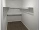 Walk-in closet featuring neutral color scheme with closet rod and shelving at 18784 E Linvale Pl, Aurora, CO 80013