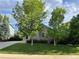Green lawn and trees enhance the curb appeal of this brick home at 18784 E Linvale Pl, Aurora, CO 80013