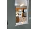 View of the kitchen features wood cabinets, white appliances, and vinyl flooring at 18784 E Linvale Pl, Aurora, CO 80013