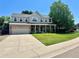 Beautiful two-story home boasts manicured lawn, mature trees, and a spacious driveway at 10512 Cimarron St, Longmont, CO 80504