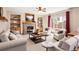 Cozy living room with a stone fireplace, built-in shelving, and comfortable seating for relaxation at 10512 Cimarron St, Longmont, CO 80504