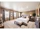 A spacious main bedroom with lots of windows and a large bed at 10512 Cimarron St, Longmont, CO 80504