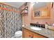 Bathroom featuring vanity with a stone countertop and a patterned shower curtain at 30400 Hilltop Dr, Evergreen, CO 80439