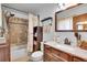 Bathroom featuring a shower, tub, toilet, vanity, and storage at 30400 Hilltop Dr, Evergreen, CO 80439