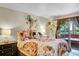 Bright bedroom featuring eclectic decor, including colorful bedding and houseplants at 30400 Hilltop Dr, Evergreen, CO 80439
