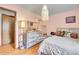 Bright bedroom featuring wood floors, modern furniture, and pastel walls at 30400 Hilltop Dr, Evergreen, CO 80439