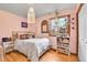 Bedroom with bright decor, stained-glass window, and wood floors at 30400 Hilltop Dr, Evergreen, CO 80439