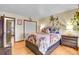 Bedroom with a colorful bedspread, wood floors, and closet at 30400 Hilltop Dr, Evergreen, CO 80439