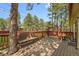 Inviting deck features a built-in bench, swing, and views of the surrounding trees at 30400 Hilltop Dr, Evergreen, CO 80439