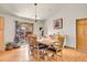 Cozy dining room featuring a wooden table set, chandelier, and sliding glass doors with exterior views at 30400 Hilltop Dr, Evergreen, CO 80439