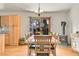 View of dining room area with wood-burning stove and light wood floors at 30400 Hilltop Dr, Evergreen, CO 80439