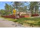 This single Gathering home is surrounded by mature trees and a private yard at 30400 Hilltop Dr, Evergreen, CO 80439