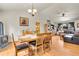 Open-concept living space with dining area, fireplace, vaulted ceilings, and a comfortable living room setup at 30400 Hilltop Dr, Evergreen, CO 80439