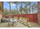 Relaxing patio with planters, seating area and mature trees at 30400 Hilltop Dr, Evergreen, CO 80439
