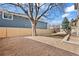 This backyard has a privacy fence, gravel area, and mature tree at 8405 W 74Th Dr, Arvada, CO 80005