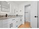 Stylish bathroom featuring a double vanity with stone countertop and modern fixtures at 8405 W 74Th Dr, Arvada, CO 80005