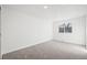 Light-filled bedroom with neutral carpet, white walls, and window bringing in natural light at 8405 W 74Th Dr, Arvada, CO 80005