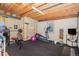 Unfinished basement area with a gym, exposed wood ceiling, framing, and concrete flooring at 6871 S Himalaya Way, Centennial, CO 80016