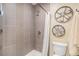 Modern bathroom featuring a tiled shower with glass doors and industrial farmhouse decor with earth tone tile at 6871 S Himalaya Way, Centennial, CO 80016