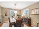 Formal dining room with hardwood floors, neutral paint, and a wooden table set for elegant gatherings at 6871 S Himalaya Way, Centennial, CO 80016