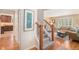 Inviting entryway with staircase, neutral paint, and adjacent view of the kitchen and living room with hardwood floors at 6871 S Himalaya Way, Centennial, CO 80016