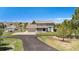 Two-story home with large front lawn, covered porch, and a driveway with a basketball hoop at 6871 S Himalaya Way, Centennial, CO 80016
