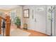 Bright foyer with hardwood floors, white front door, and access to a staircase at 6871 S Himalaya Way, Centennial, CO 80016