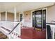 Welcoming front porch with rocking chairs and dark stained wood flooring at 6871 S Himalaya Way, Centennial, CO 80016