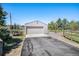 Large detached garage with an asphalt driveway and some surrounding trees at 6871 S Himalaya Way, Centennial, CO 80016