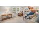 Bright, open-concept living room with access to the kitchen and featuring hardwood floors and lots of natural light at 6871 S Himalaya Way, Centennial, CO 80016