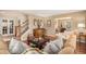 Well-lit living room boasts a cozy atmosphere with hardwood floors, comfortable seating, and stylish decor at 6871 S Himalaya Way, Centennial, CO 80016