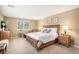 Serene main bedroom featuring a plush king bed, warm colors, and ample natural light from large windows at 6871 S Himalaya Way, Centennial, CO 80016