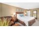 Cozy main bedroom with a comfortable king-sized bed, a leather chair, and soft, neutral tones throughout at 6871 S Himalaya Way, Centennial, CO 80016