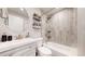 This bathroom has light gray tiles, an undermount sink, a shower/tub, and a mirror above the sink at 13485 Niagara St, Thornton, CO 80602
