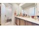 This bathroom has a double vanity with a marble countertop, and a shower/tub combination at 13485 Niagara St, Thornton, CO 80602