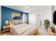 This bedroom has two-toned walls, a light-colored wood bedframe, and an attached bathroom at 13485 Niagara St, Thornton, CO 80602