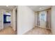 This bedroom is adjacent to another room and has a beige carpet and neutral walls, and a large window at 13485 Niagara St, Thornton, CO 80602