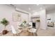 This dining room has a wet bar, seating for four, and a plant next to the dining table at 13485 Niagara St, Thornton, CO 80602