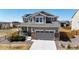 Charming two-story home features a well-manicured lawn, concrete driveway and two-car garage at 13485 Niagara St, Thornton, CO 80602