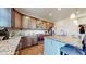 Kitchen featuring an island with barstool seating, stainless appliances, granite countertops, and ample cabinet space at 13485 Niagara St, Thornton, CO 80602