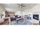 Inviting living room open to the kitchen featuring hardwood floors, a fireplace, and comfortable furniture at 13485 Niagara St, Thornton, CO 80602