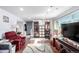 Spacious basement area featuring wood-look flooring, comfortable seating, and a staircase to the upper level at 717 Anderson St, Castle Rock, CO 80104