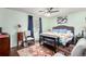 Relaxing bedroom with hardwood floors, light green walls, and a floral comforter, offering a peaceful and comfortable space at 717 Anderson St, Castle Rock, CO 80104