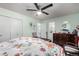 Bright bedroom features a ceiling fan, dresser, and a doorway to the bathroom at 717 Anderson St, Castle Rock, CO 80104