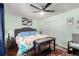 Calm bedroom with hardwood floors, ample natural light, and a ceiling fan, creating a comfortable and inviting atmosphere at 717 Anderson St, Castle Rock, CO 80104