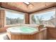 An enclosed hot tub with views from the surrounding windows at 717 Anderson St, Castle Rock, CO 80104