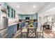 Open kitchen concept, connecting with living room, featuring two-tone cabinets, stainless steel appliances, and ample counter space at 717 Anderson St, Castle Rock, CO 80104