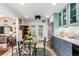 Bright eat-in kitchen with access to the living room, featuring two-tone cabinets and stainless steel appliances, for convenience at 717 Anderson St, Castle Rock, CO 80104